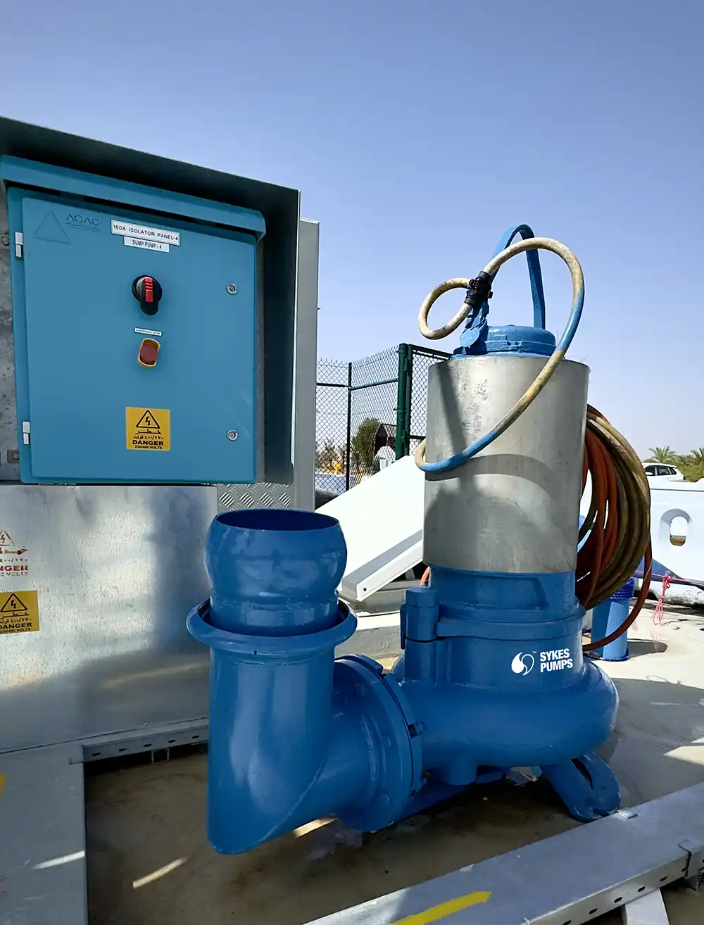 The KE203 submersible pump deployed on-site, connected to discharge piping and the control panel.