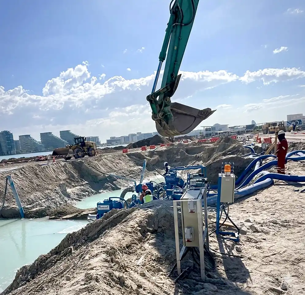 High-capacity industrial pumps controlling groundwater inflow at a coastal infrastructure excavation site.