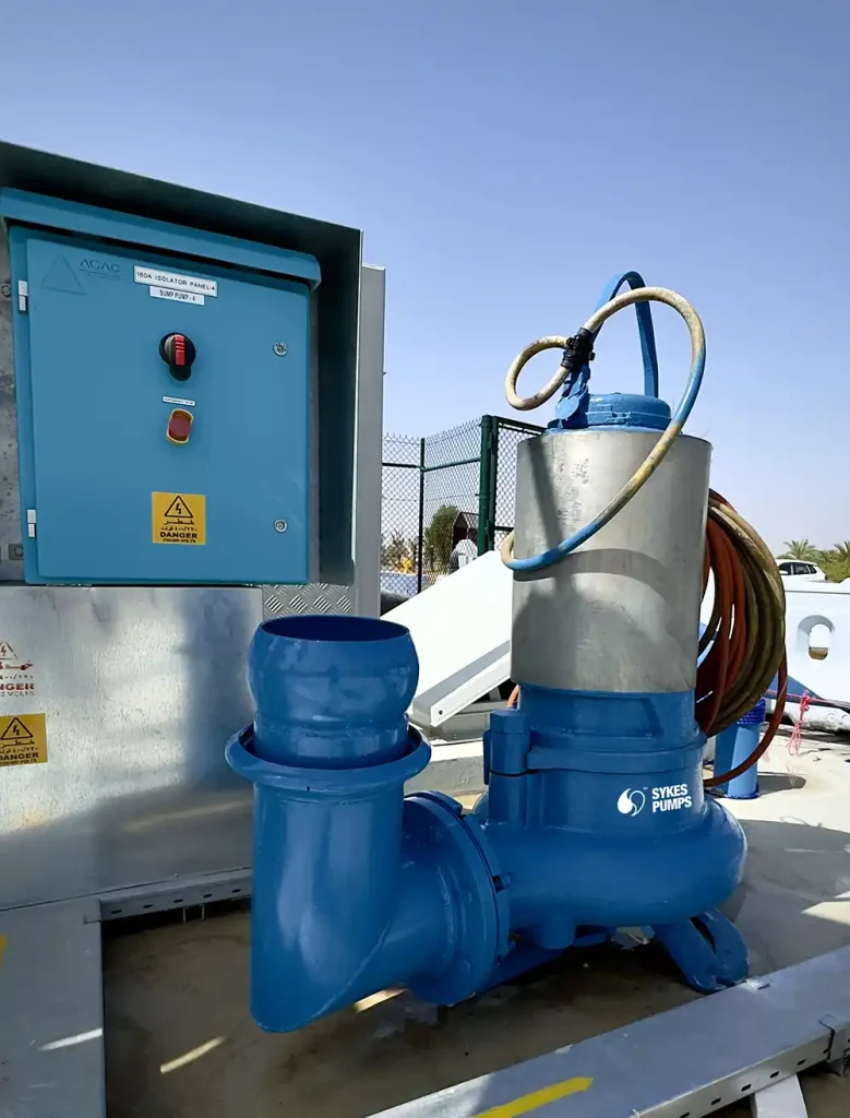 The KE203 submersible pump deployed on-site, connected to discharge piping and the control panel.